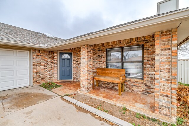 view of exterior entry with a garage