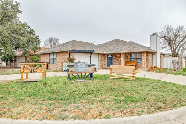 ranch-style home with a garage and a front lawn