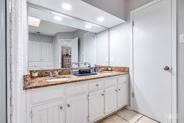 bathroom featuring vanity and a skylight