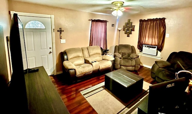 living room featuring ceiling fan and dark hardwood / wood-style flooring