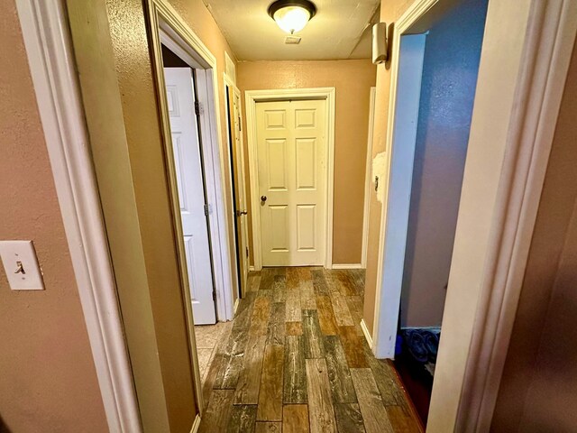 hall with dark wood-type flooring