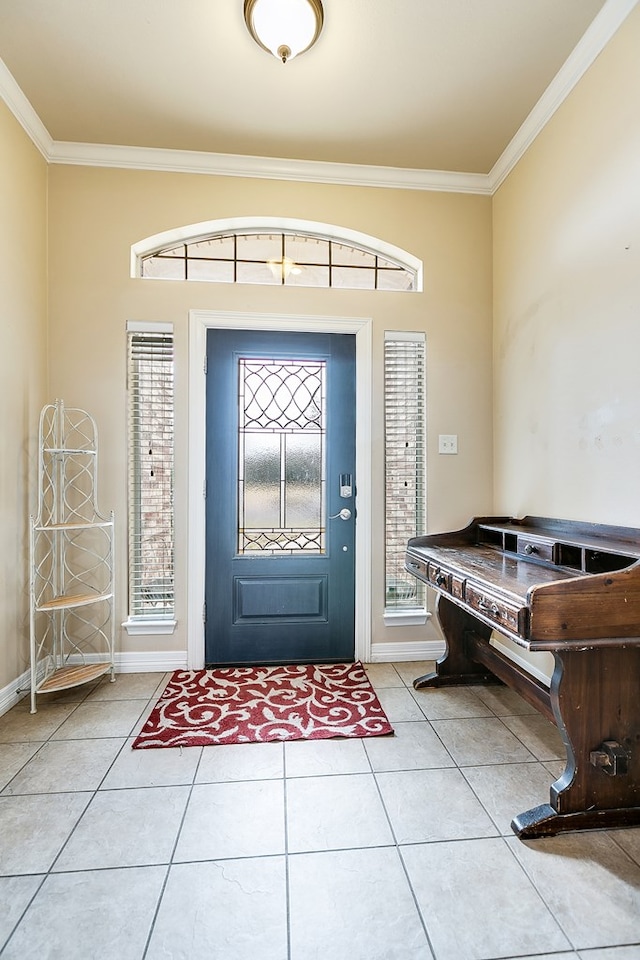 foyer featuring crown molding, light tile patterned floors, and baseboards