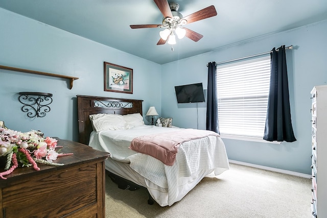 carpeted bedroom featuring ceiling fan and baseboards