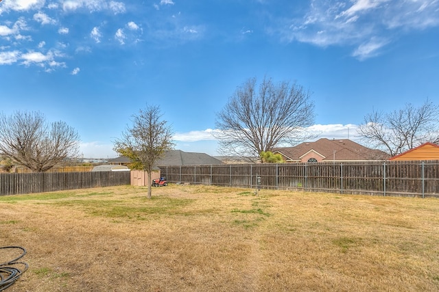 view of yard with an outdoor structure and a fenced backyard