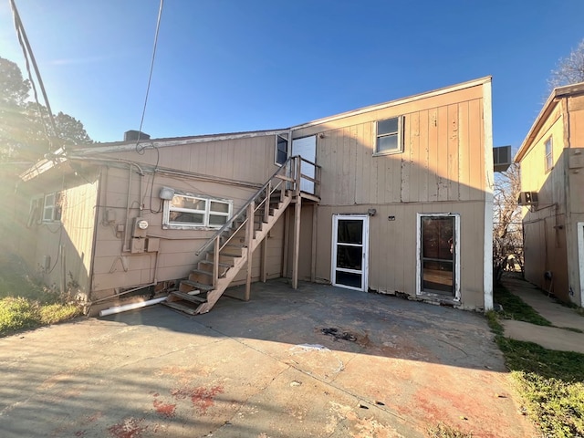 back of property with an AC wall unit