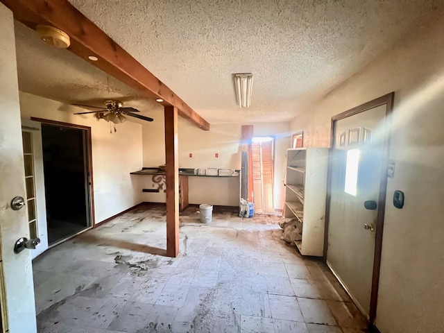 interior space featuring ceiling fan and a textured ceiling