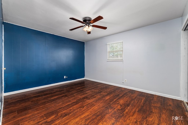 empty room with hardwood / wood-style floors and ceiling fan