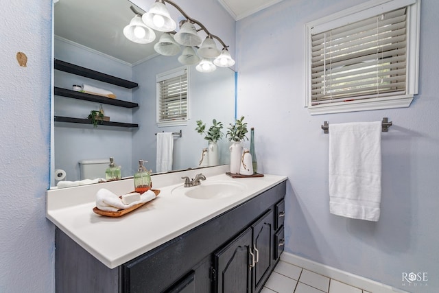 bathroom with tile patterned flooring, vanity, crown molding, and toilet