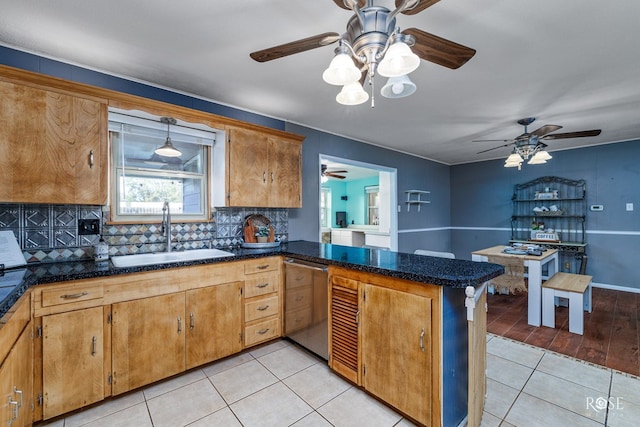 kitchen with dishwasher, sink, backsplash, light tile patterned floors, and kitchen peninsula