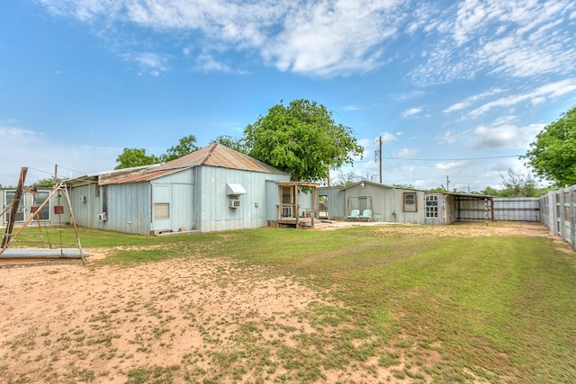 back of property with a fenced backyard and a yard
