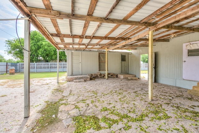 view of patio with an exterior structure, an outbuilding, and a carport
