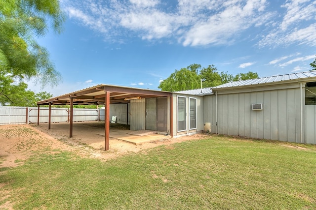 view of outdoor structure with fence and an AC wall unit
