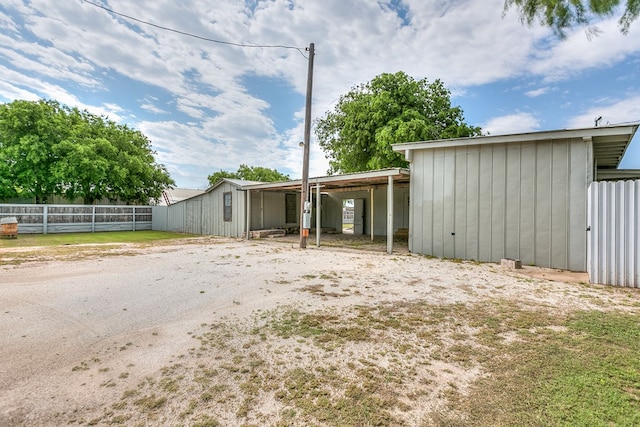 exterior space featuring an outdoor structure and fence