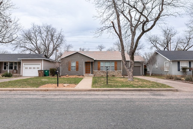 single story home featuring a front yard and a garage