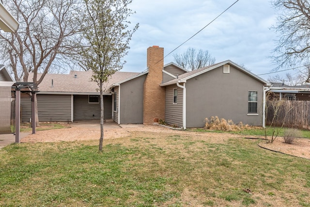 rear view of property featuring a yard