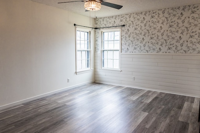 spare room with a textured ceiling, hardwood / wood-style floors, and ceiling fan