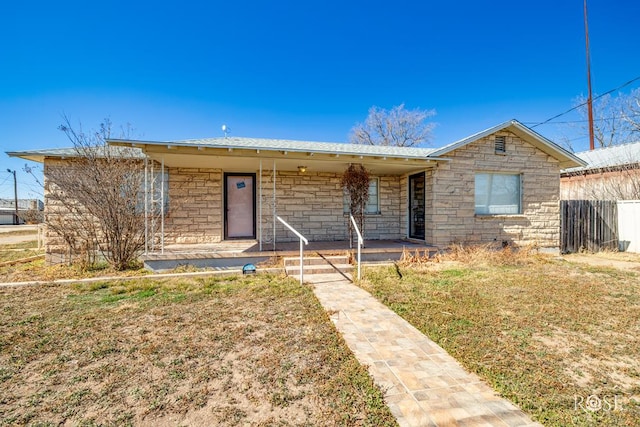 single story home with a porch and a front yard