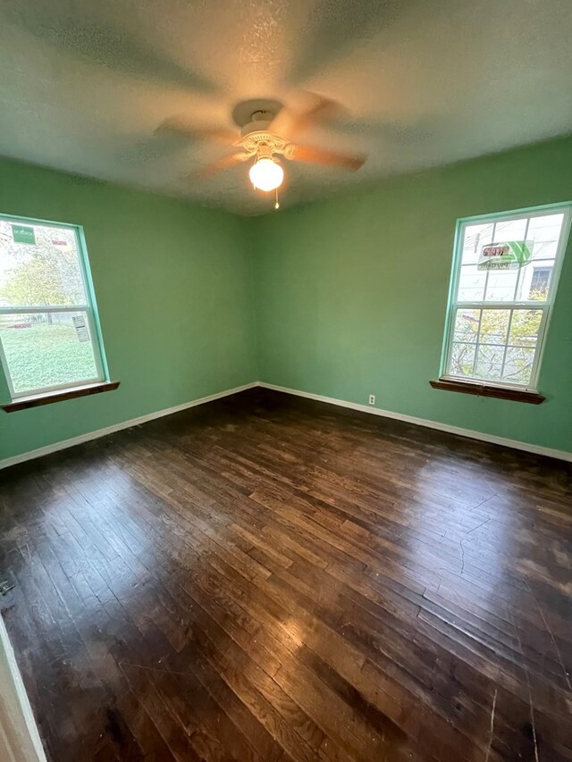 20 E 39th St, San Angelo, TX 76903 - unfurnished room featuring dark wood-style flooring, a ceiling fan, baseboards, and a textured ceiling