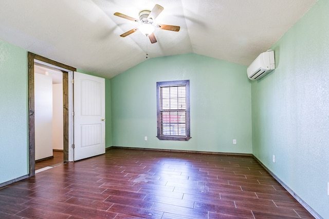 unfurnished bedroom featuring vaulted ceiling, dark wood-type flooring, ceiling fan, and a wall unit AC