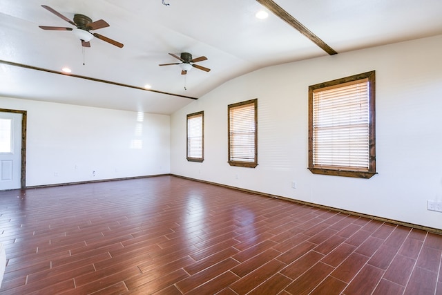 spare room with dark wood-type flooring, ceiling fan, and vaulted ceiling