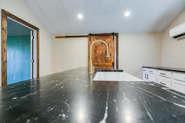 interior details featuring sink, a barn door, and a wall mounted AC