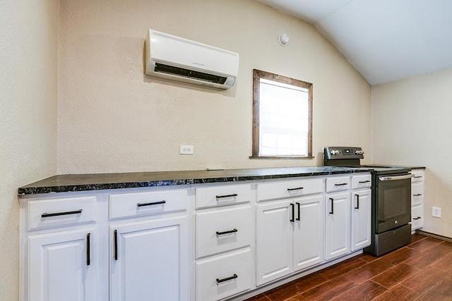 kitchen featuring lofted ceiling, dark wood-type flooring, electric range oven, a wall mounted AC, and white cabinets