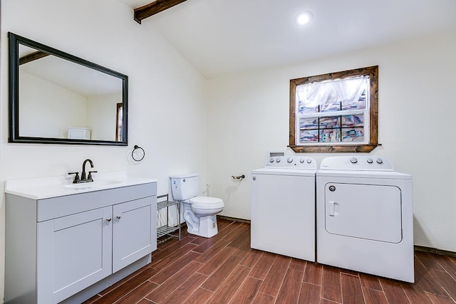 clothes washing area featuring sink and washer and clothes dryer