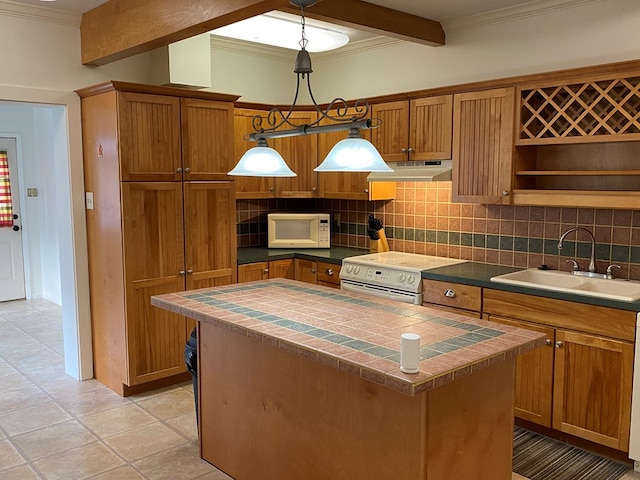 kitchen with range with electric stovetop, tasteful backsplash, sink, hanging light fixtures, and a center island