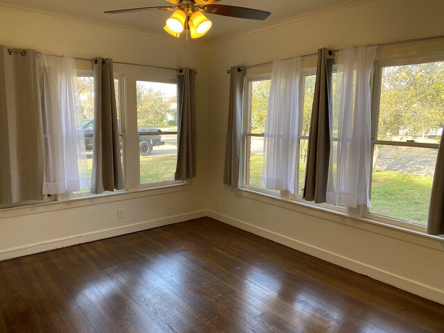 unfurnished room featuring crown molding, dark hardwood / wood-style floors, and ceiling fan