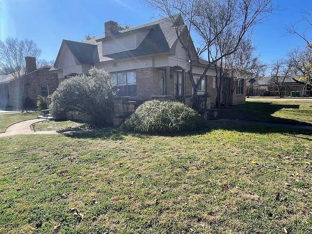 view of side of home featuring a lawn