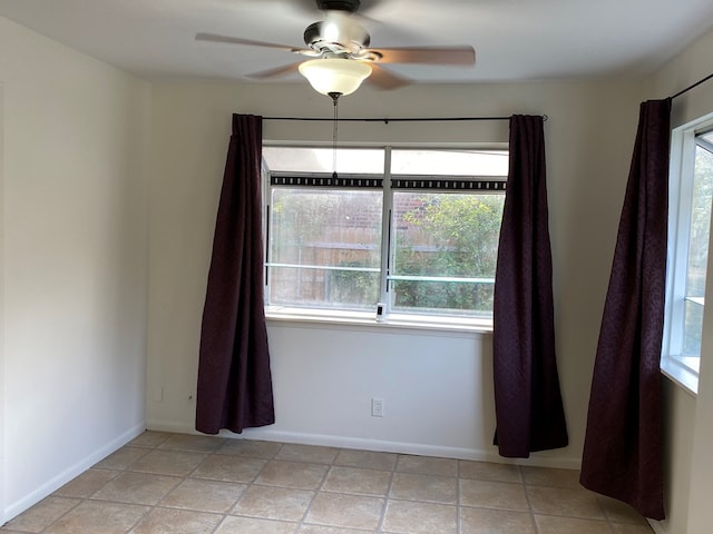 empty room featuring plenty of natural light and ceiling fan