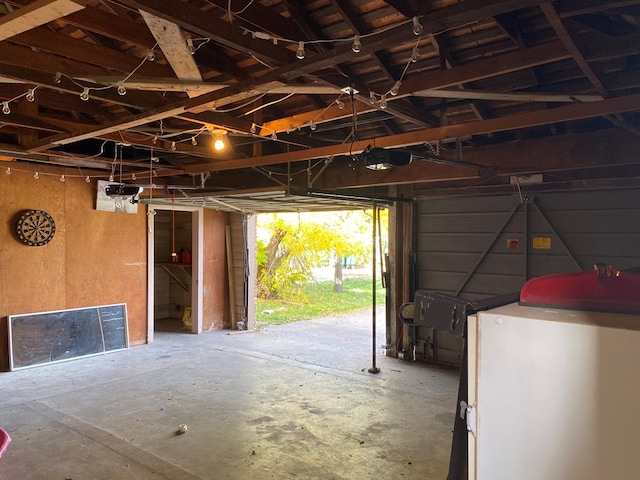 garage featuring washer / dryer and white refrigerator