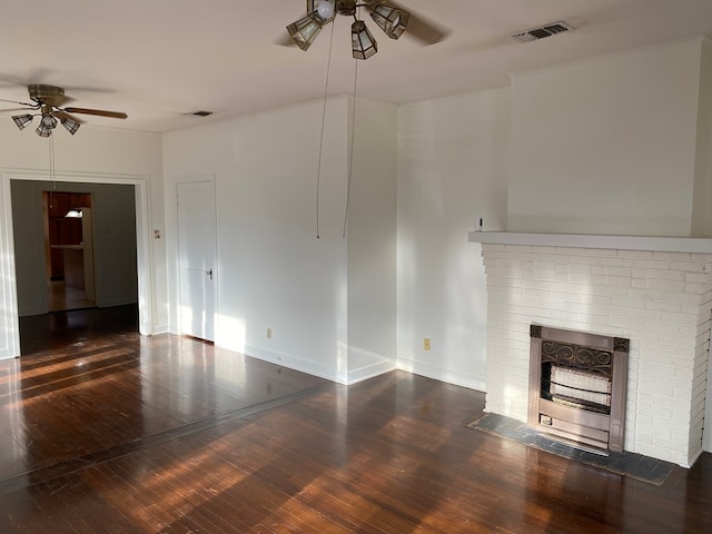 unfurnished living room with a brick fireplace, dark hardwood / wood-style floors, and ceiling fan