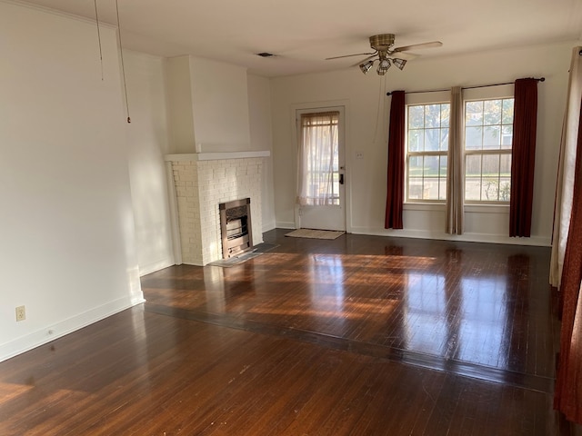 unfurnished living room with dark wood-type flooring, ceiling fan, and a fireplace