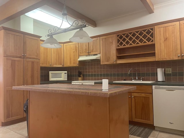 kitchen featuring a kitchen island, tasteful backsplash, sink, hanging light fixtures, and white appliances