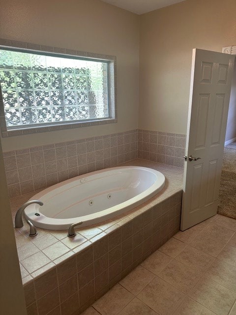 full bath with tile patterned floors and a jetted tub