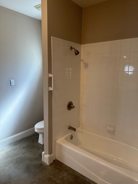 bathroom featuring concrete floors, visible vents, baseboards, toilet, and shower / bathtub combination