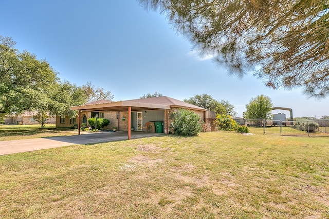 1027 Butterfly Ln, San Angelo, TX 76905 - view of yard featuring a carport and concrete driveway