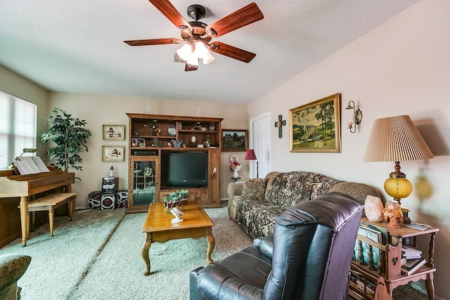 1027 Butterfly Ln, San Angelo, TX 76905 - carpeted living area featuring ceiling fan and a textured ceiling