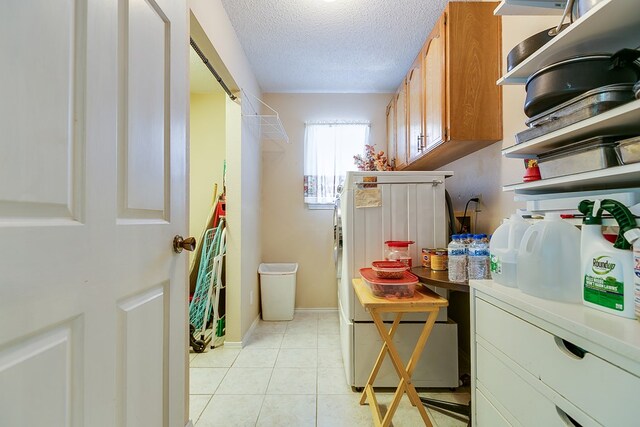 1027 Butterfly Ln, San Angelo, TX 76905 - washroom featuring a textured ceiling and light tile patterned flooring