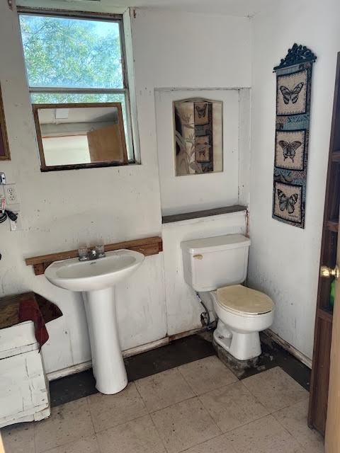 8523 Runion Rd, San Angelo, TX 76905 - half bathroom with toilet and a sink