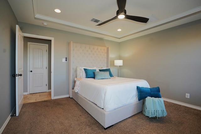 bedroom featuring ceiling fan, ornamental molding, carpet flooring, and a raised ceiling