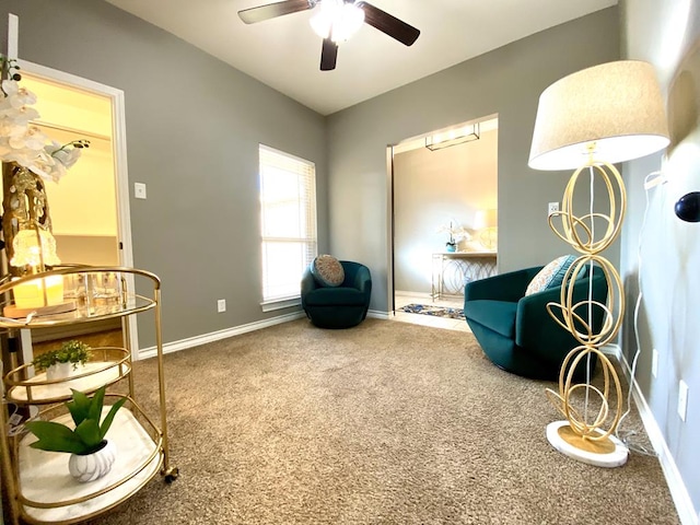 living area featuring carpet floors and ceiling fan