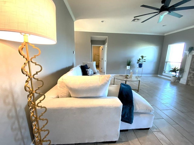 living room featuring ornamental molding and ceiling fan