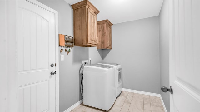 laundry area with cabinets and separate washer and dryer