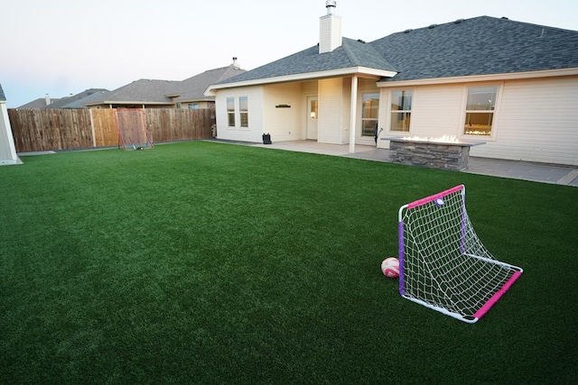 back of house featuring a patio area and a lawn