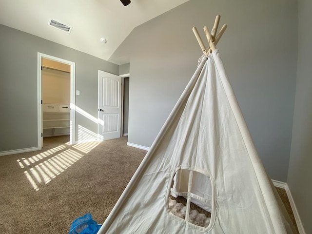 unfurnished bedroom featuring ceiling fan, lofted ceiling, and carpet