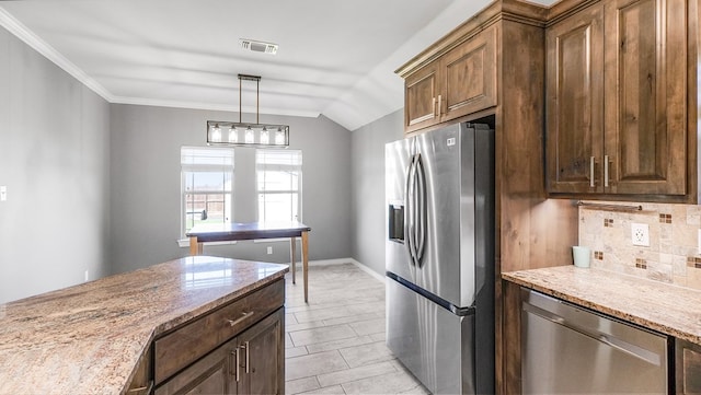 kitchen featuring lofted ceiling, stainless steel appliances, tasteful backsplash, light stone counters, and decorative light fixtures