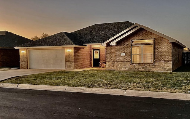 view of front facade with a garage and a yard