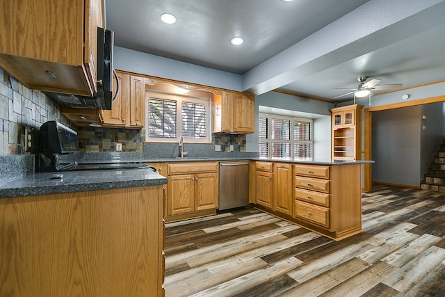 kitchen with sink, wood-type flooring, stainless steel dishwasher, kitchen peninsula, and backsplash